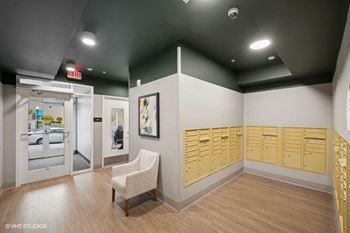 a locker room with a chair and wooden cabinets